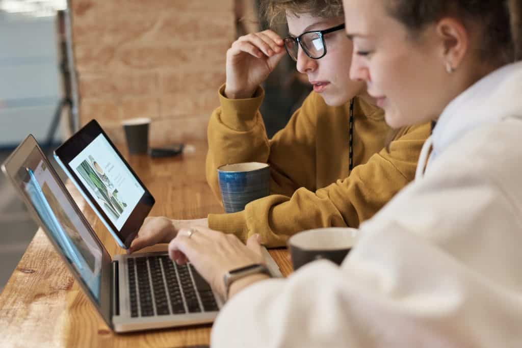 Two women looking at a laptop screen